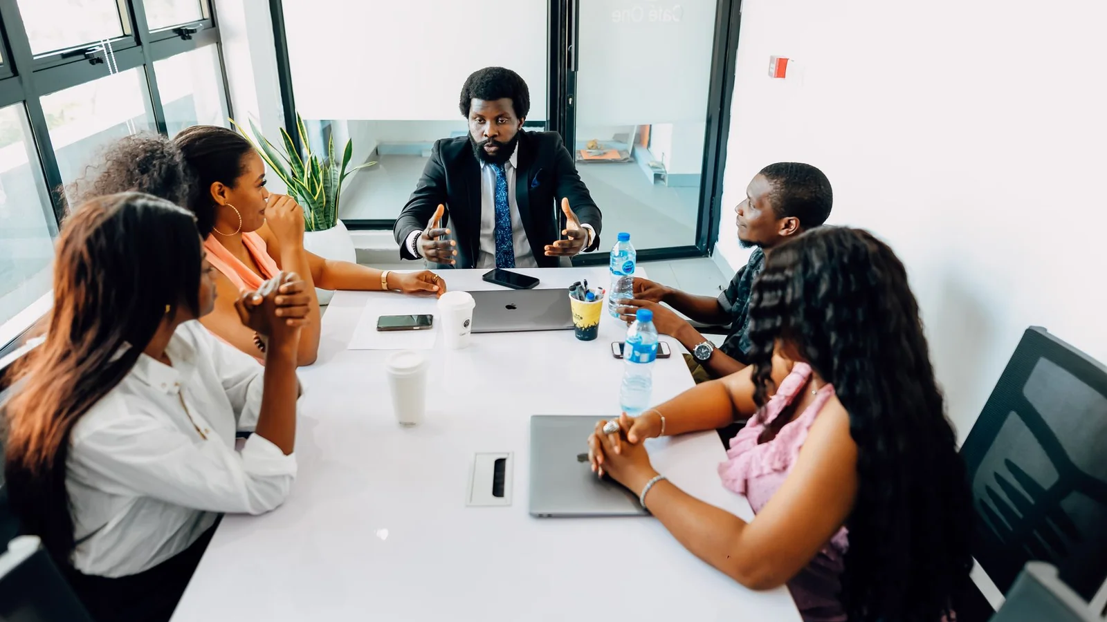 Business professionals discussing operational priorities in a Lagos office