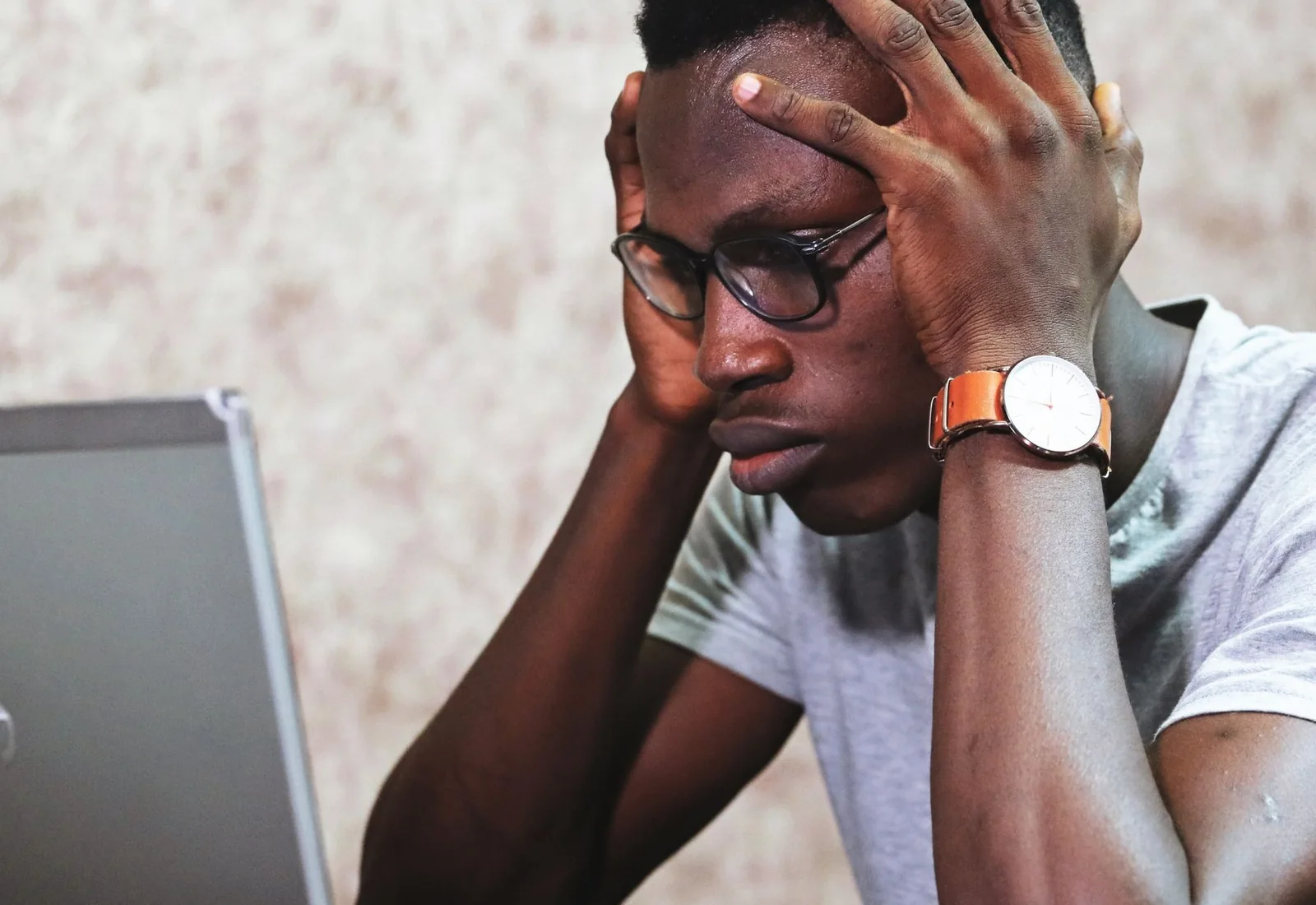 A professional experiencing frustration while using a laptop